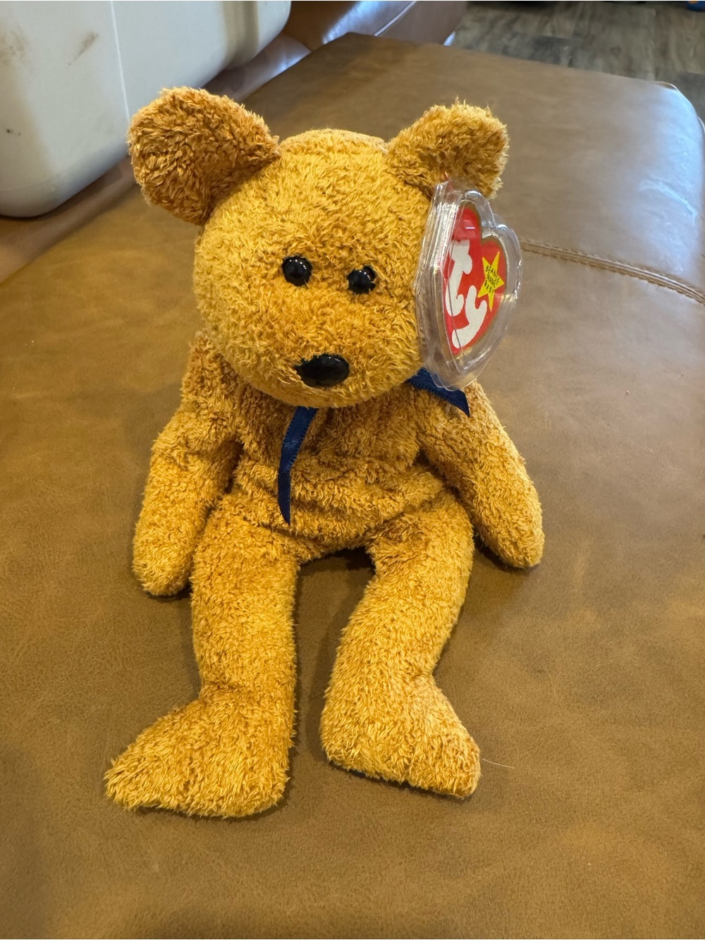 This is a 1999 Ty Beanie Baby plush toy named "Fuzz".